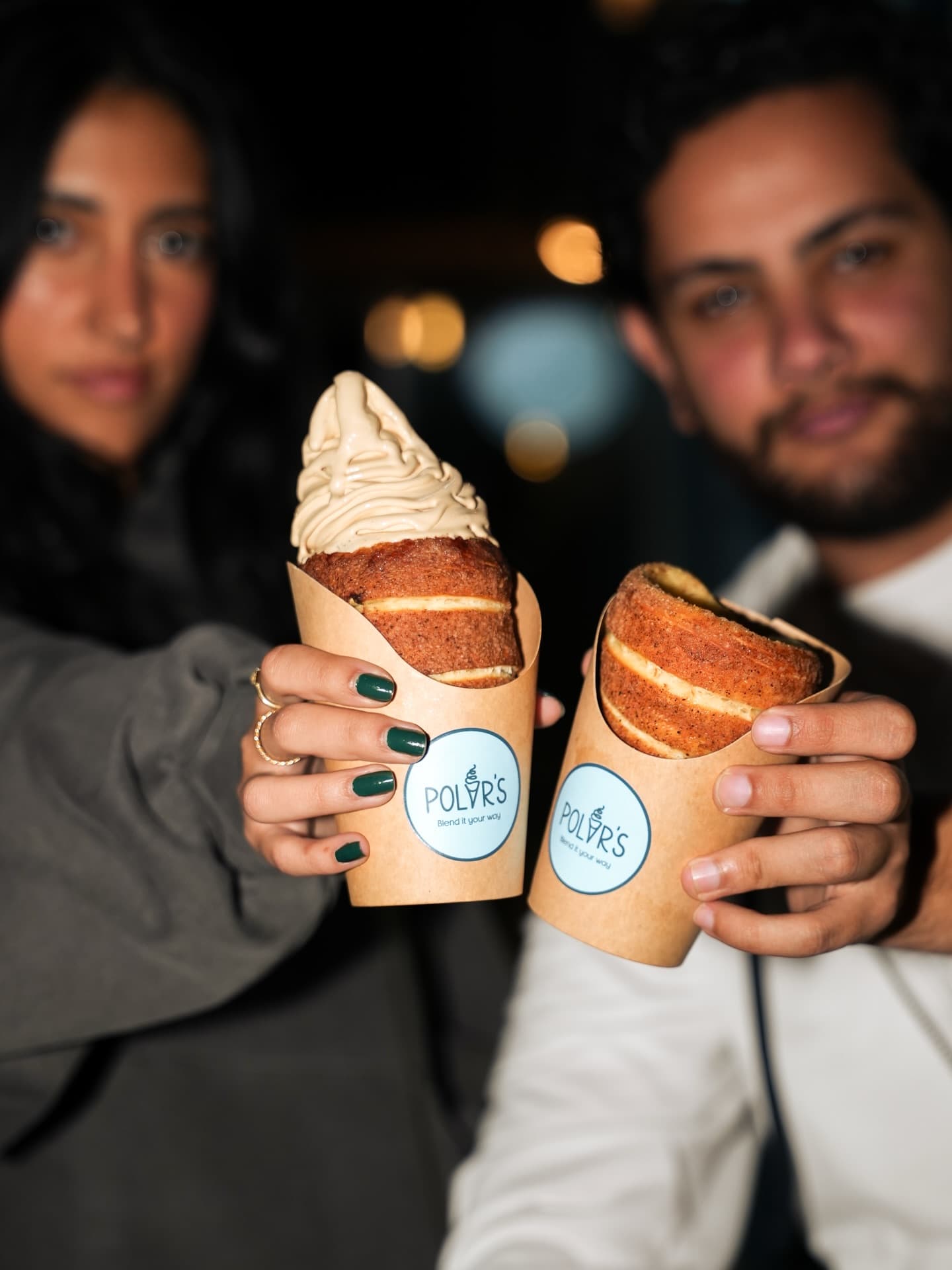 Couple holding ice creams